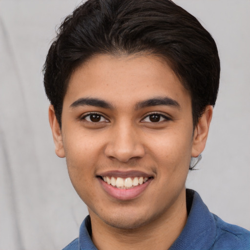 Joyful latino young-adult male with short  brown hair and brown eyes