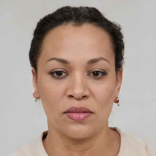 Joyful latino adult female with short  brown hair and brown eyes