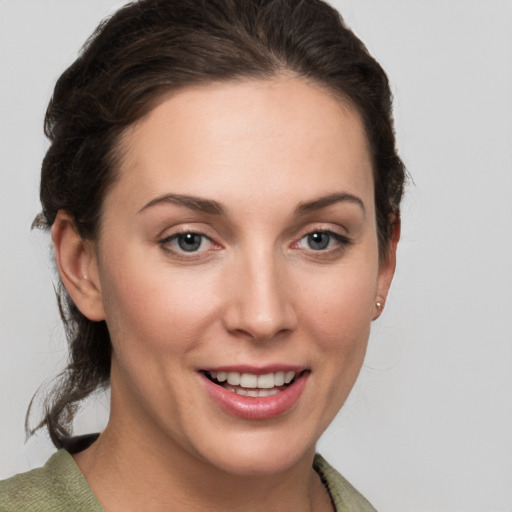 Joyful white young-adult female with medium  brown hair and grey eyes