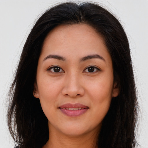 Joyful latino young-adult female with long  brown hair and brown eyes