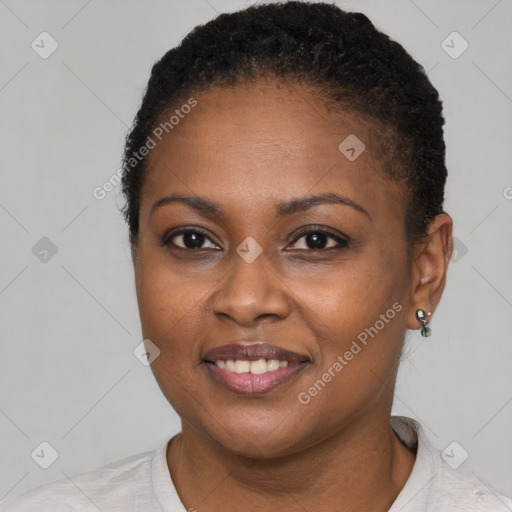 Joyful black young-adult female with short  black hair and brown eyes