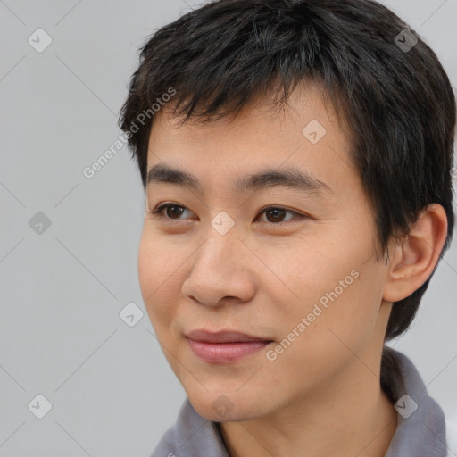 Joyful asian young-adult male with short  brown hair and brown eyes