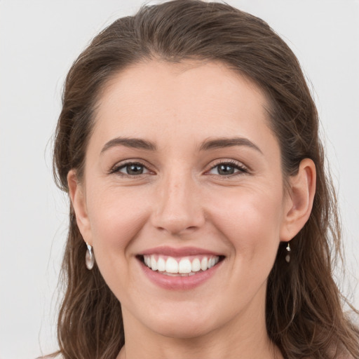 Joyful white young-adult female with long  brown hair and grey eyes