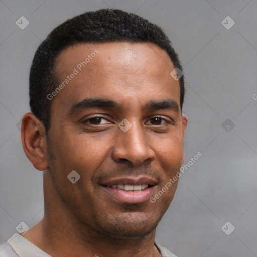 Joyful black young-adult male with short  brown hair and brown eyes