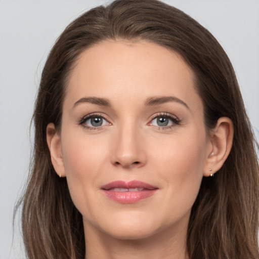 Joyful white young-adult female with long  brown hair and grey eyes