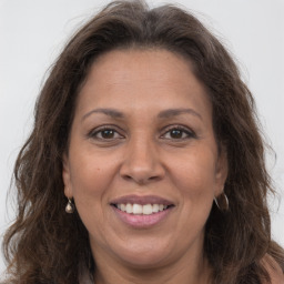 Joyful white adult female with long  brown hair and brown eyes