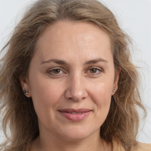 Joyful white adult female with long  brown hair and grey eyes