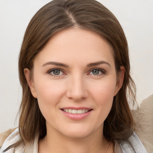 Joyful white young-adult female with medium  brown hair and grey eyes