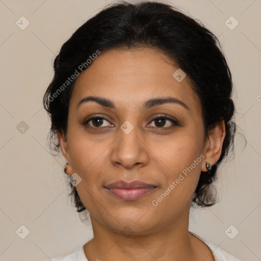 Joyful latino adult female with medium  brown hair and brown eyes