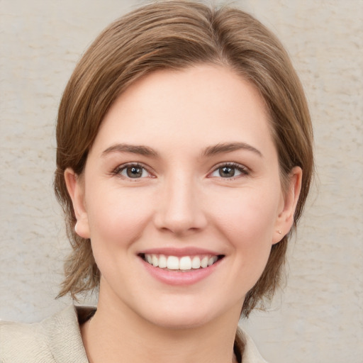 Joyful white young-adult female with medium  brown hair and grey eyes