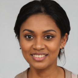 Joyful latino young-adult female with medium  black hair and brown eyes