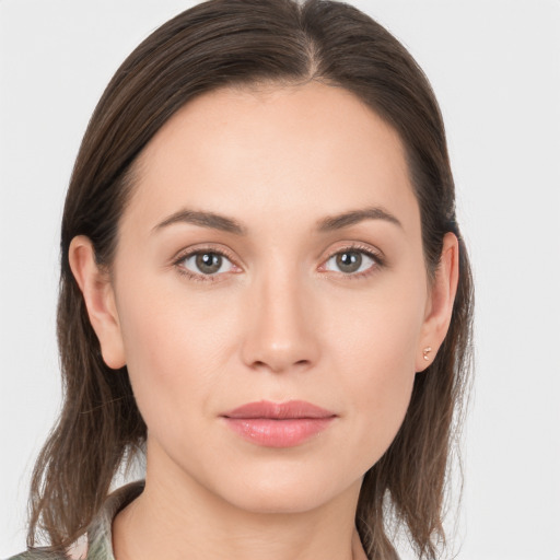 Joyful white young-adult female with long  brown hair and grey eyes