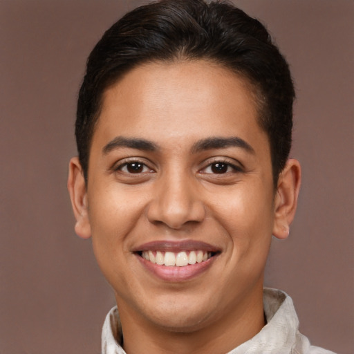 Joyful latino young-adult male with short  brown hair and brown eyes