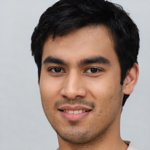 Joyful asian young-adult male with short  black hair and brown eyes