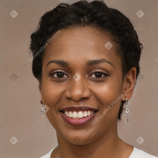 Joyful black young-adult female with short  black hair and brown eyes