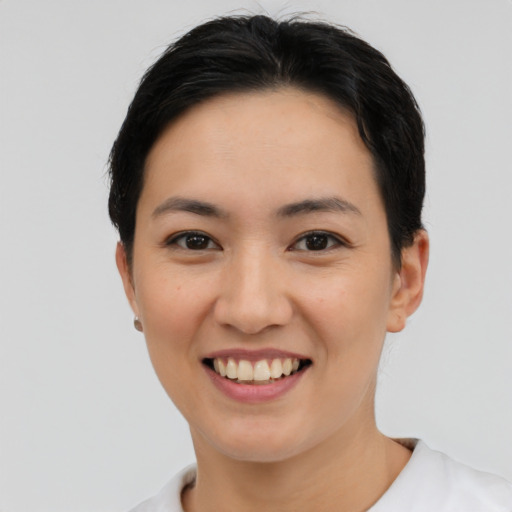 Joyful asian young-adult female with short  black hair and brown eyes