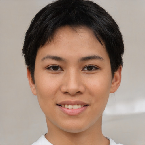 Joyful asian young-adult female with short  brown hair and brown eyes