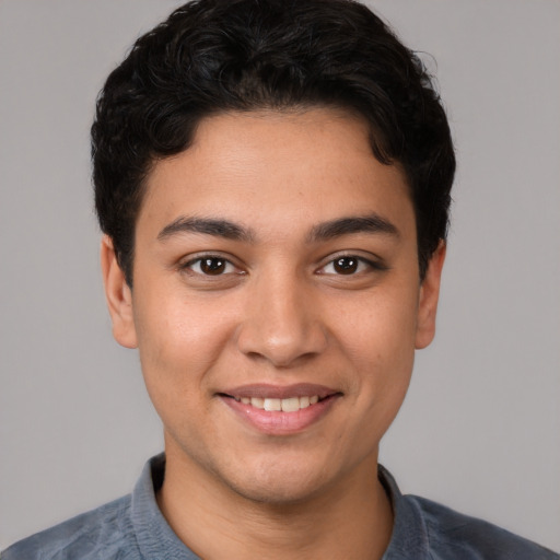 Joyful white young-adult male with short  black hair and brown eyes