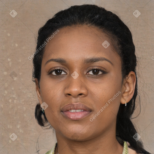 Joyful black young-adult female with long  black hair and brown eyes