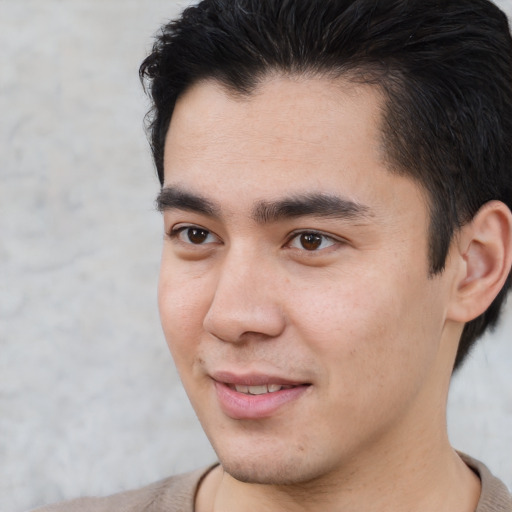 Joyful asian young-adult male with short  brown hair and brown eyes