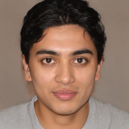 Joyful latino young-adult male with short  brown hair and brown eyes