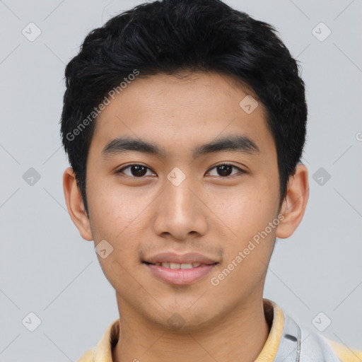Joyful asian young-adult male with short  black hair and brown eyes