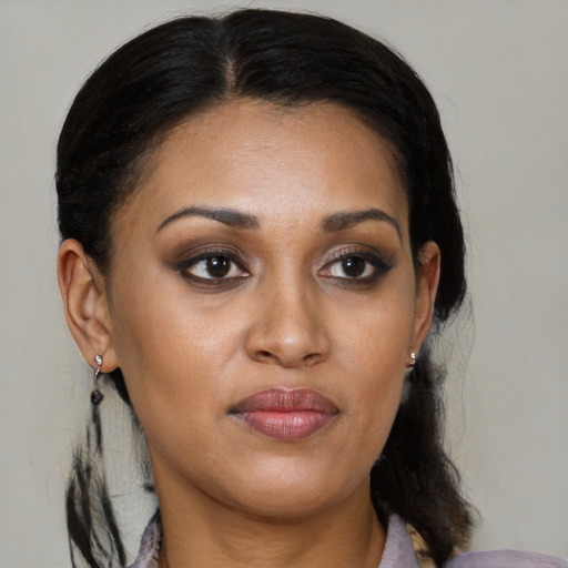Joyful black young-adult female with medium  brown hair and brown eyes