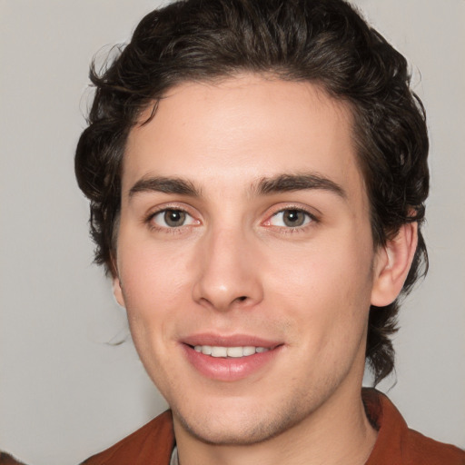 Joyful white young-adult male with medium  brown hair and brown eyes