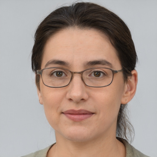 Joyful white adult female with medium  brown hair and brown eyes