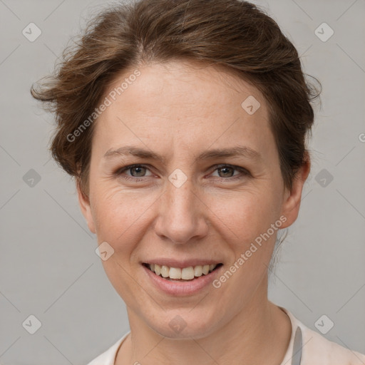 Joyful white adult female with short  brown hair and grey eyes