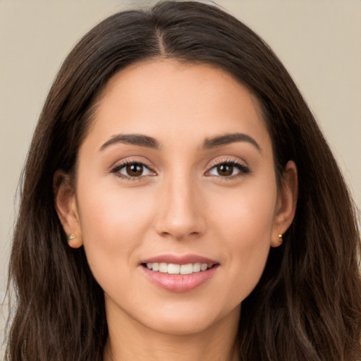 Joyful white young-adult female with long  brown hair and brown eyes