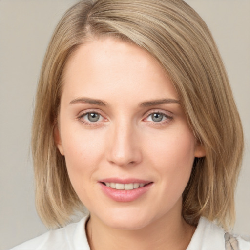 Joyful white young-adult female with medium  brown hair and blue eyes