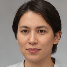 Joyful white adult female with medium  brown hair and brown eyes