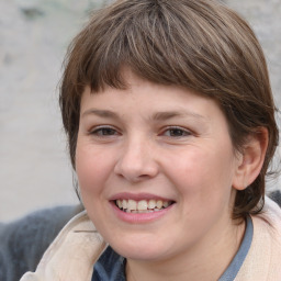 Joyful white young-adult female with medium  brown hair and blue eyes