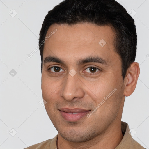 Joyful white young-adult male with short  black hair and brown eyes