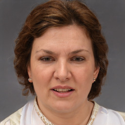 Joyful white adult female with medium  brown hair and blue eyes