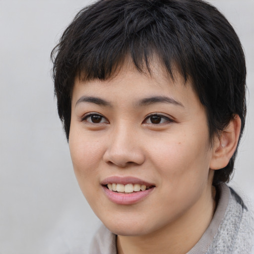 Joyful asian young-adult female with short  brown hair and brown eyes