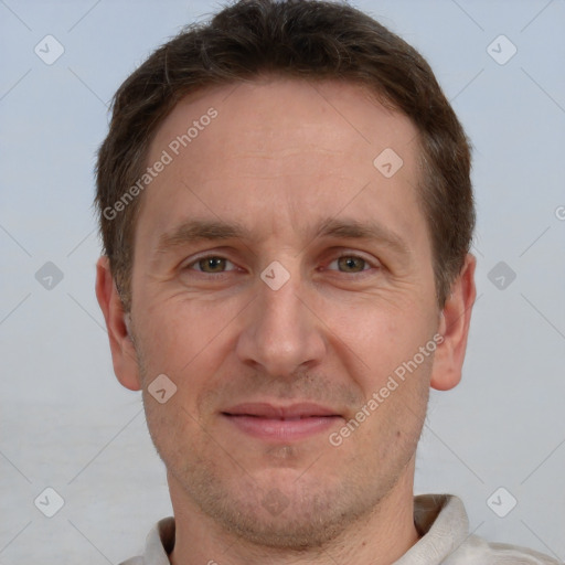 Joyful white adult male with short  brown hair and grey eyes