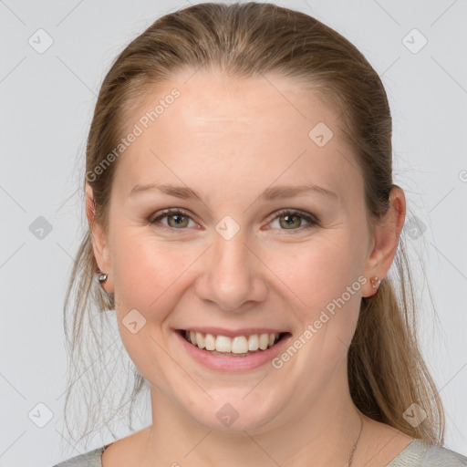 Joyful white young-adult female with medium  brown hair and grey eyes