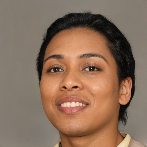 Joyful latino young-adult female with medium  black hair and brown eyes