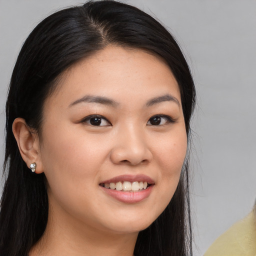 Joyful white young-adult female with long  black hair and brown eyes