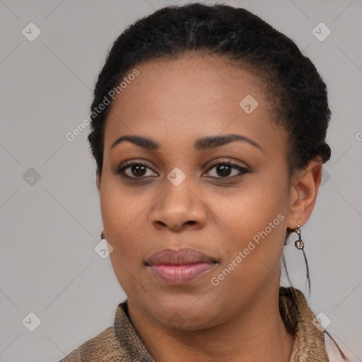 Joyful black young-adult female with short  black hair and brown eyes