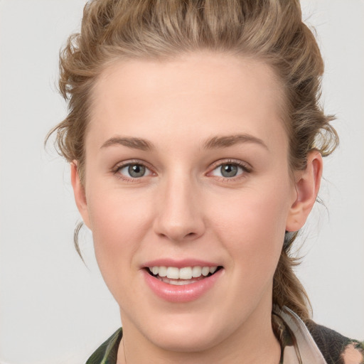 Joyful white young-adult female with medium  brown hair and blue eyes