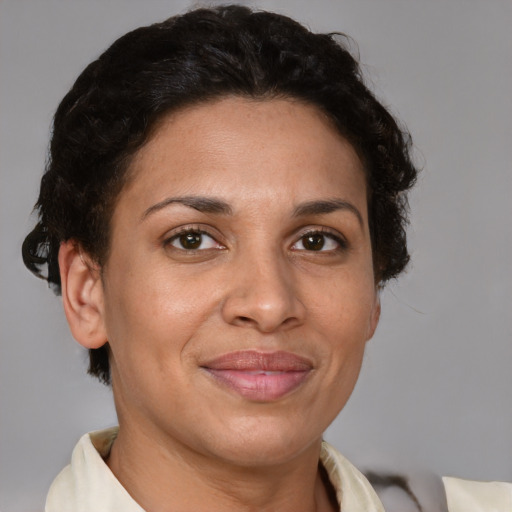 Joyful latino adult female with short  brown hair and brown eyes