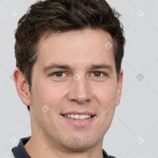 Joyful white adult male with short  brown hair and grey eyes