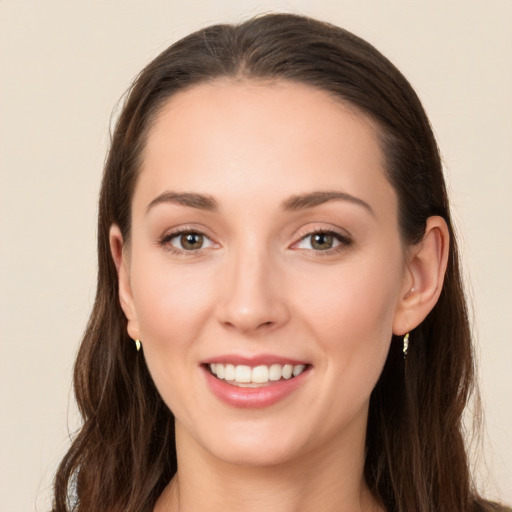 Joyful white young-adult female with long  brown hair and brown eyes