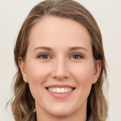 Joyful white young-adult female with long  brown hair and grey eyes