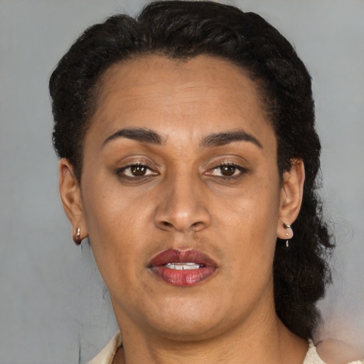 Joyful latino adult female with short  brown hair and brown eyes