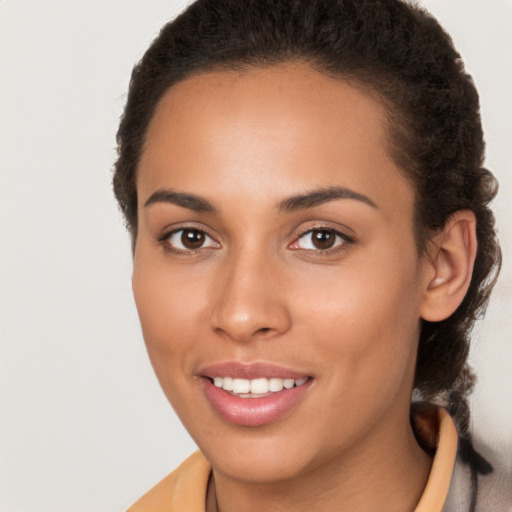 Joyful latino young-adult female with long  brown hair and brown eyes