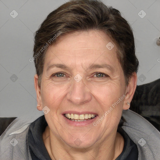 Joyful white adult female with medium  brown hair and grey eyes